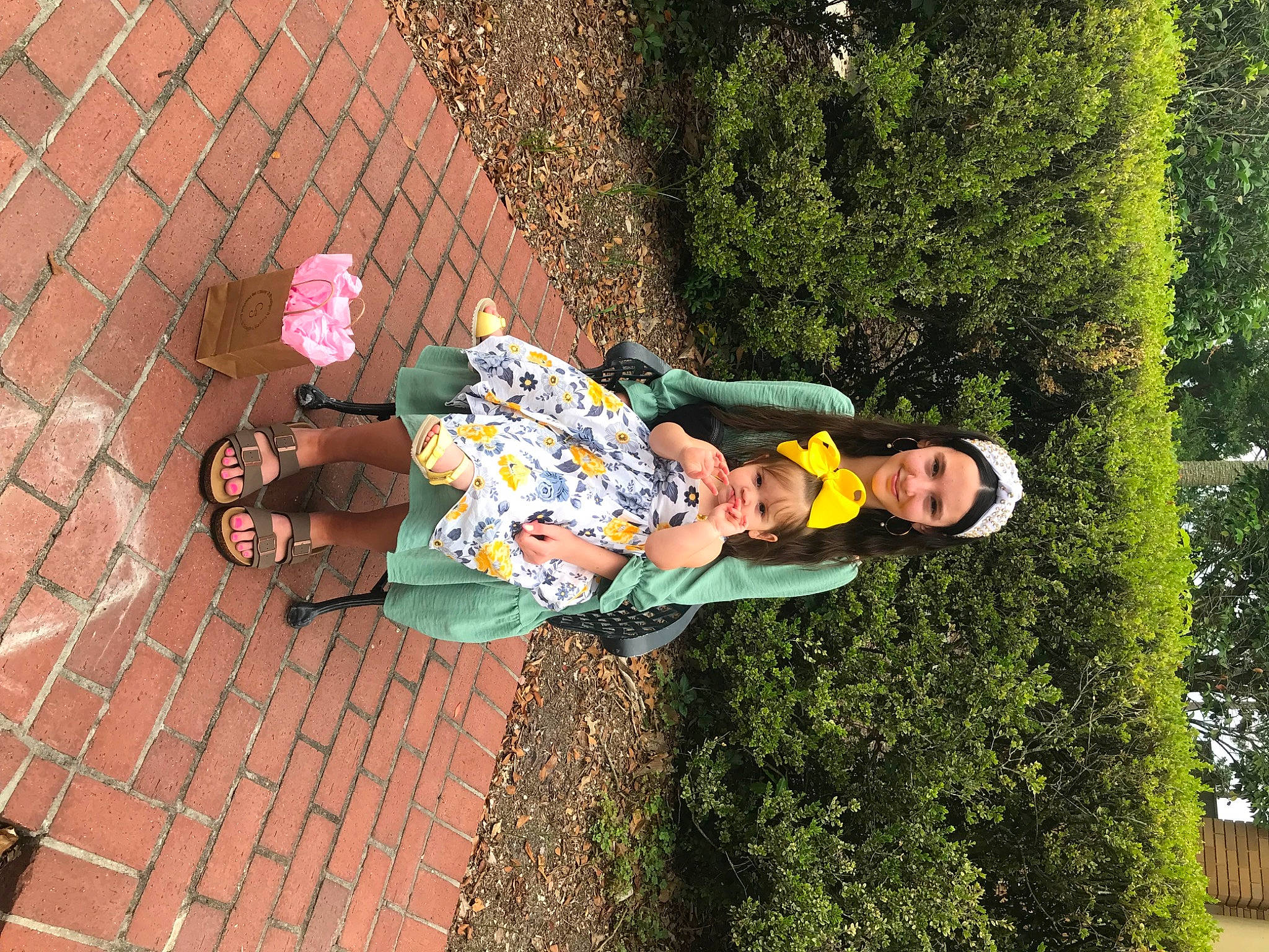 Emerald is registered to the contest to win money with this photo: brick, child, flooring, fun, garden, grass, grass_family, happy, headwear, human_leg, joy, leisure, people_in_nature, person, plant, recreation, road_surface, sandal, shrub, sidewalk