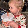 child, toddler, portrait, profile, sitting, indoors, living_room, fireplace, pajamas, reindeer, holiday, cup, straw, fast_food, drink, burger_king, hands, blonde_hair, cozy, family_home