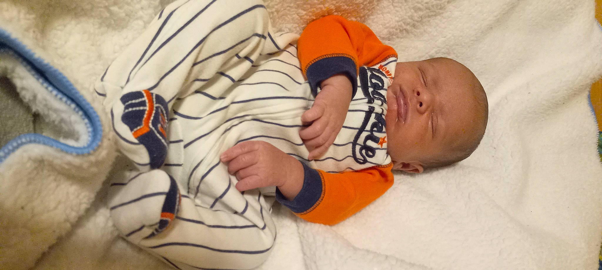 Marcus is registered to the contest to win money with this photo: art, baby, baby_sleeping, baby_toddler_clothing, carmine, child, comfort, gesture, illustration, jersey, linens, orange, pattern, person, sleeve, sports_uniform, sportswear, t_shirt, textile, toddler