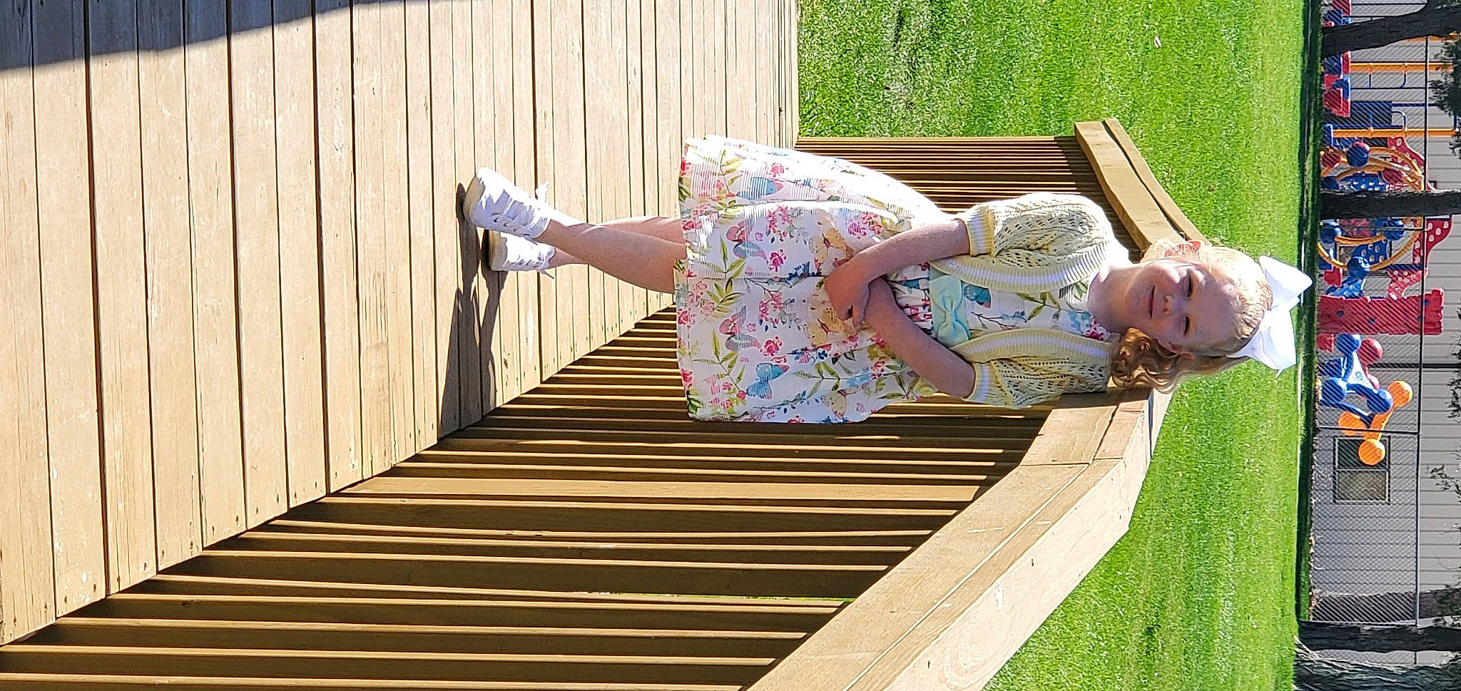 Genessa joined the competition — help win amazing prizes! child, dress, flooring, fun, grass, green, handrail, hardwood, human_leg, joy, leisure, pattern, people_in_nature, person, recreation, sitting, stairs, thigh, waist, wood