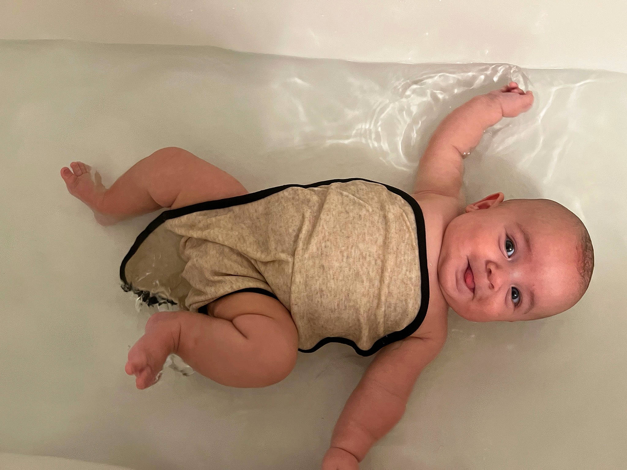 E Zayvier is registered to the contest to win money with this photo: baby, baby_toddler_clothing, barefoot, bathtub, chest, comfort, elbow, floor, flooring, foot, hair, human_body, human_leg, joint, knee, leg, person, sleeve, stomach, thigh
