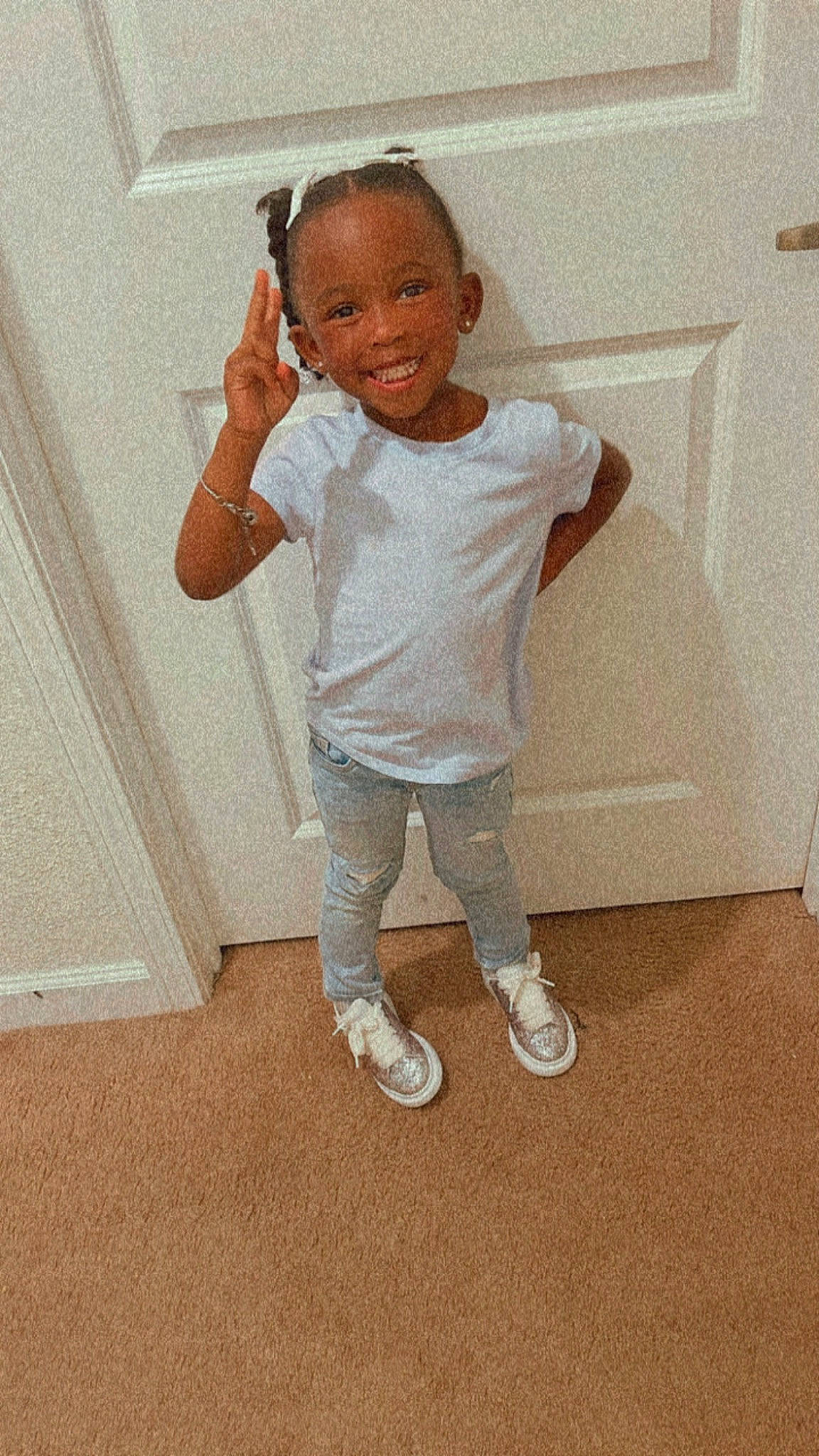 Sage Davis is registered to the contest to win money with this photo: baby_toddler_clothing, door, elbow, eye, face, floor, flooring, gesture, hair, happy, human_body, human_leg, joy, knee, leg, neck, person, sleeve, smile, t_shirt