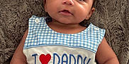 Myles joined the competition — help win amazing prizes! baby, infant, child, blue_clothing, checkered_pattern, embroidered_text, heart_symbol, daddy_message, plush_blanket, soft_texture, cute, chubby_cheeks, lying_down, small_hands, curious_expression, natural_light, portrait, indoors, comfortable, smiling