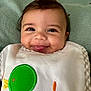 baby, infant, smile, tongue, bib, green_bird_patch, closeup, face, cheeks, eyes, clothing, blanket, cute, happy, child, portrait, babywear, expression, indoor, young