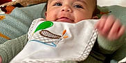 Myles is registered to the contest to win money with this photo: baby, babywear, bib, blanket, child, closeup, clothing, cozy, cute, fabric, face, foot, happy, head, indoor, infant, person, portrait, smile, soft