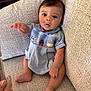 baby, child, infant, blue_dress, couch, furniture, indoor, person, sitting, cute, curious, hand, foot, face, expression, texture, home, relaxing, comfort, young