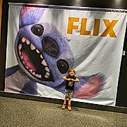 Myla joined the competition — help win amazing prizes! advertisement, banner, blue, boots, cartoon_character, child, eyes, floor, hands, indoor, lighting, nose, pose, shorts, smile, standing, teeth, tshirt, wall, yellow_ceiling