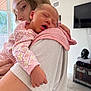 Eloise joined the competition — help win amazing prizes! baby, sleeping, woman, holding, indoor, pajamas, pink, face, arm, hand, window, light, furniture, blanket, home, person, portrait, relaxation, cozy, toddler
