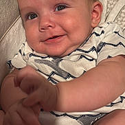 Jose is registered to the contest to win money with this photo: baby, child, infant, smile, face, hand, onesie, clothing, skin, person, cute, happy, indoors, closeup, expression, young, portrait, babywear, fingertips, drool