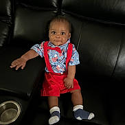 Tajhire is registered to the contest to win money with this photo: baby, child, infant, sitting, couch, leather_couch, red_suspender, blue_shirt, bow_tie, socks, indoor, furniture, portrait, cute, face, smile, hand, footwear, comfortable, looking