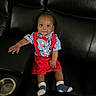 baby, child, infant, sitting, couch, leather_couch, red_suspender, blue_shirt, bow_tie, socks, indoor, furniture, portrait, cute, face, smile, hand, footwear, comfortable, looking