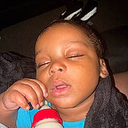 Tajhire is registered to the contest to win money with this photo: baby, sleepy, milk_bottle, hand, blanket, close_up, infant, person, child, face, cozy, resting, cute, indoors, young, skin, eyelashes, mouth, clothing, portrait