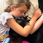 Tony Stuart joined the competition — help win amazing prizes! animal, bed, black_cat, blanket, child, comfort, cozy, curly_hair, cute, earring, friendship, hugging, indoor, peaceful, pet, pillow, relaxation, resting, sleeping, white_tshirt