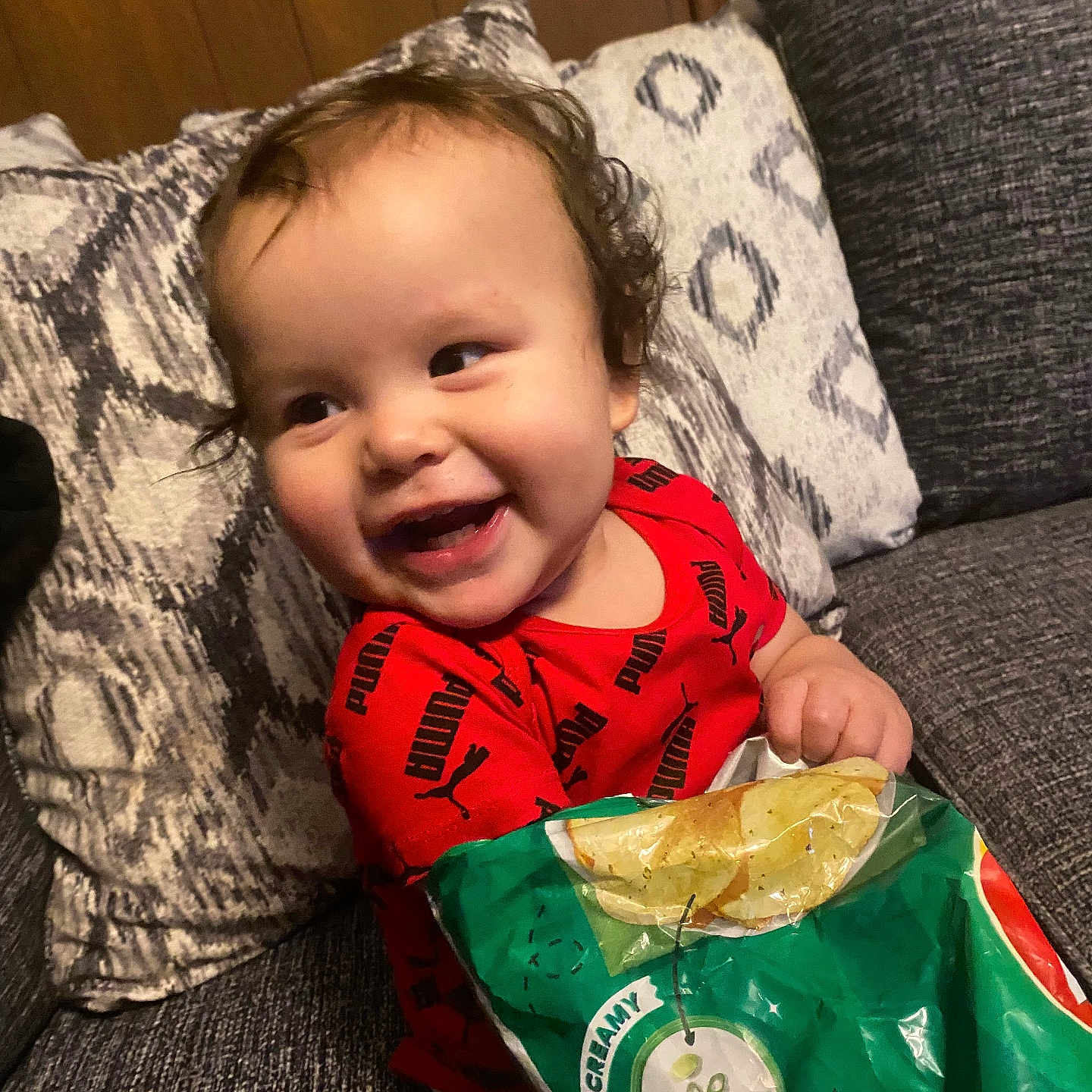 Jaxon is registered to the contest to win money with this photo: baby, babylaughing, ball, bread, couch, cushion, face, food, football, furniture, happy, head, homedecor, person, photography, pillow, portrait, soccer, soccerball, sport