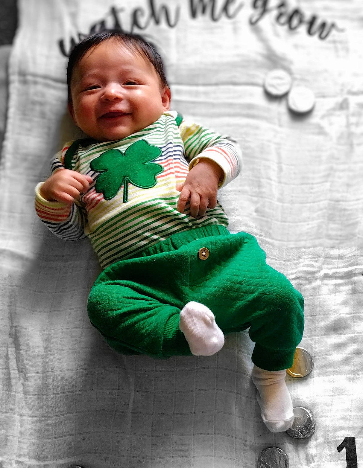 De'Angelo is registered to the contest to win money with this photo: arm, baby, baby_products, baby_toddler_clothing, child, eye, gesture, grass, happy, head, human_body, joy, person, play, portrait_photography, sitting, skin, sleeve, smile, t_shirt