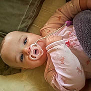 Elly joined the competition — help win amazing prizes! baby, pacifier, pajamas, blanket, cushion, face, child, infant, resting, indoors, soft_toys, plush, comfort, sleepwear, cute, hand, blue_eyes, closeup, lying_down, peaceful
