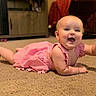 Elly is registered to the contest to win money with this photo: baby, pink_dress, carpet, indoor, smiling, happy, crawling, fireplace, warm, cozy, child, cute, infant, home, floor, person, waving, cheerful, living_room, portrait
