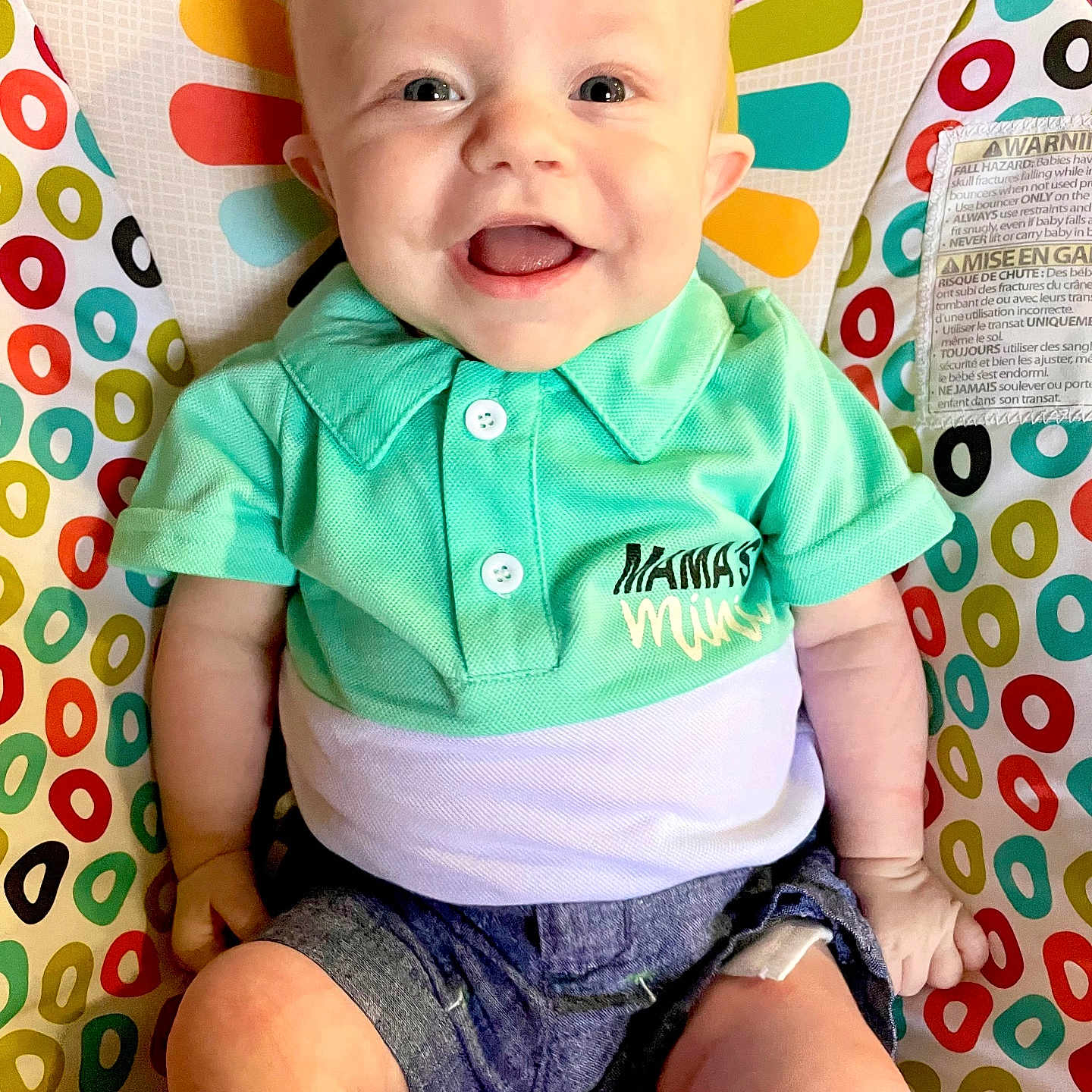 Gunner is registered to the contest to win money with this photo: accessories, baby, babylaughing, clothing, cushion, face, happy, head, homedecor, jeans, laughing, pants, person, photography, portrait, shirt, shorts, sitting, smile, t_shirt