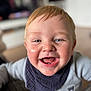 Hudson is registered to the contest to win money with this photo: toddler, child, smiling, face, blue_eyes, happy, indoor, portrait, clothing, bib, baby, cute, young_child, person, head, skin, hair, expression, cheerful, closeup