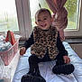 toddler, child, smile, leopard_print, vest, black_boots, changing_pad, window, pink_curtains, baby_supplies, diapers, basket, indoor, happy, person, clothing, face, hair, furniture, room