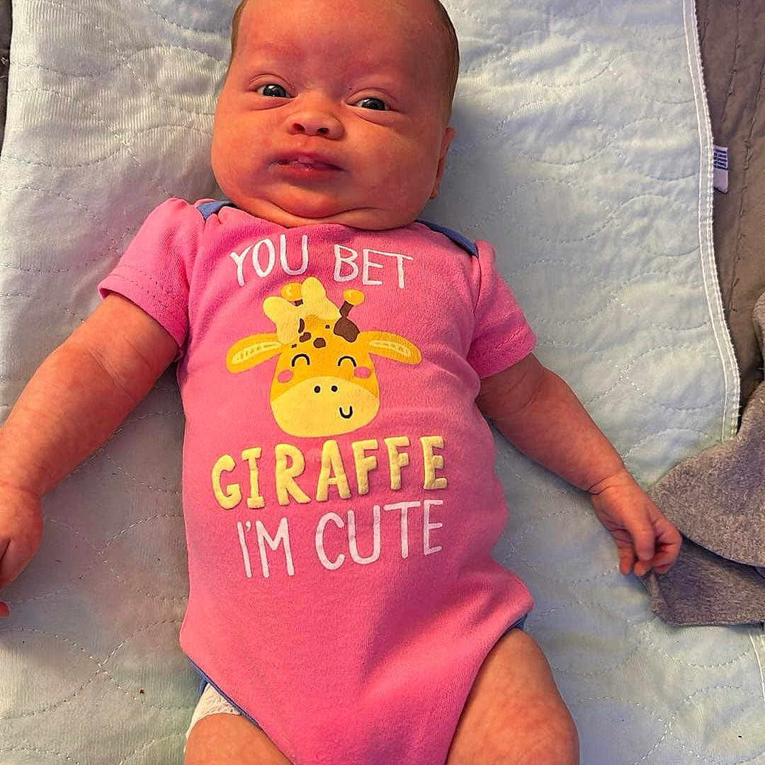 Ophelia is registered to the contest to win money with this photo: baby, bed, bedroom, clothing, cushion, diaper, face, furniture, head, homedecor, indoors, newborn, person, photography, portrait, quilt, room, sitting, sleeping, t_shirt