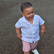 Wilfred is registered to the contest to win money with this photo: toddler, child, boy, white_shirt, pink_shorts, white_sneakers, bracelet, walking, outdoor, pavement, confident, short_hair, casual_clothing, daylight, cute, smiling, fashion, young, person, portrait