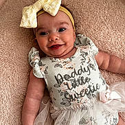 Zara is registered to the contest to win money with this photo: baby, smiling, headband, bow, onesie, floral, tulle, blanket, cute, happy, infant, toddler, portrait, soft, pink, skin, face, child, lying, apparel