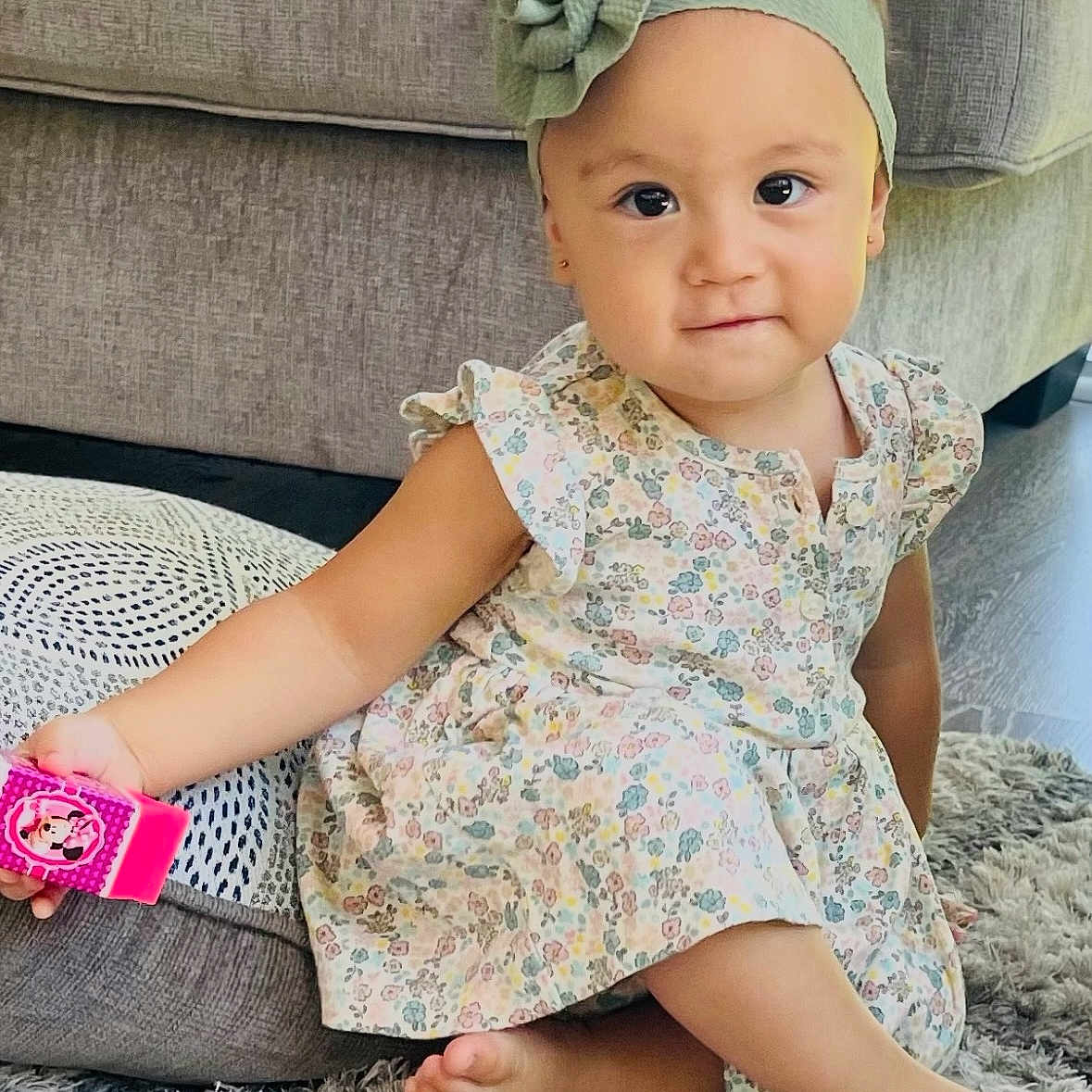 Jovana is registered to the contest to win money with this photo: barefoot, carpet, child, couch, cute, floral_dress, flower, furniture, girl, headband, home, indoor, pink, playful, rug, sitting, smiling, toddler, toy, young_child