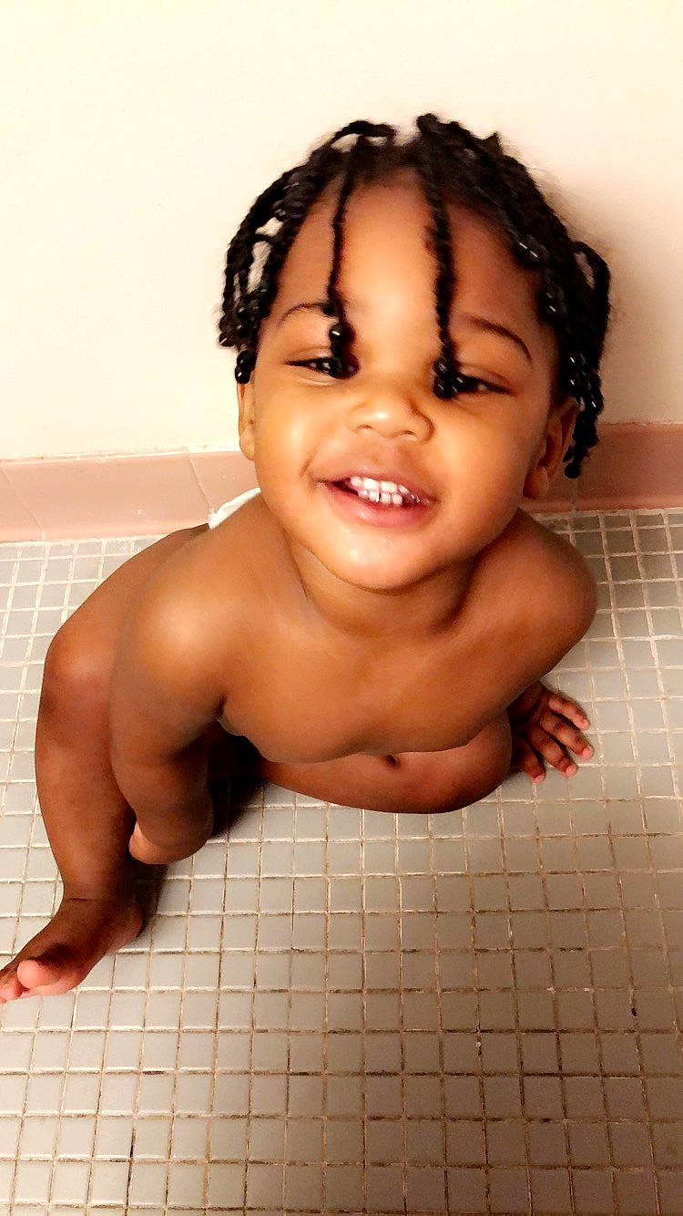 Terrell is registered to the contest to win money with this photo: baby, bathing, black_hair, cheek, child, eyebrow, face, forehead, hair, head, joy, lip, mouth, muscle, nose, person, skin, smile, toddler