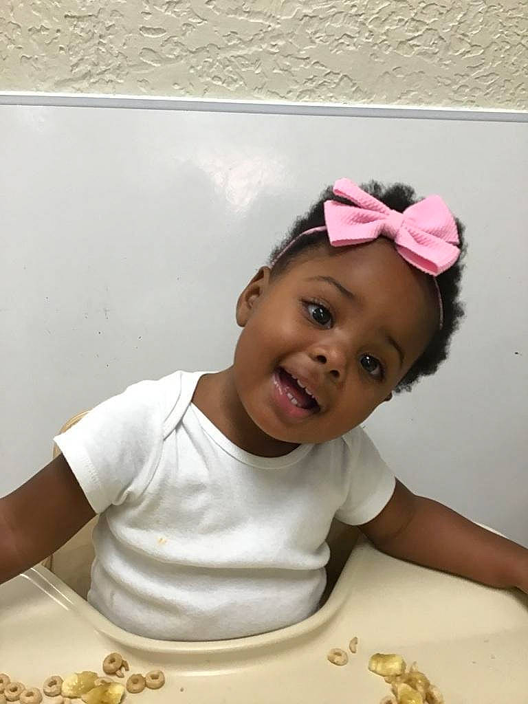 Kennedy is registered to the contest to win money with this photo: baby, baseball_cap, cap, chair, child, comfort_food, cuisine, dish, fashion_accessory, fun, happy, hat, magenta, person, portrait_photography, smile, sweetness, t_shirt, toddler