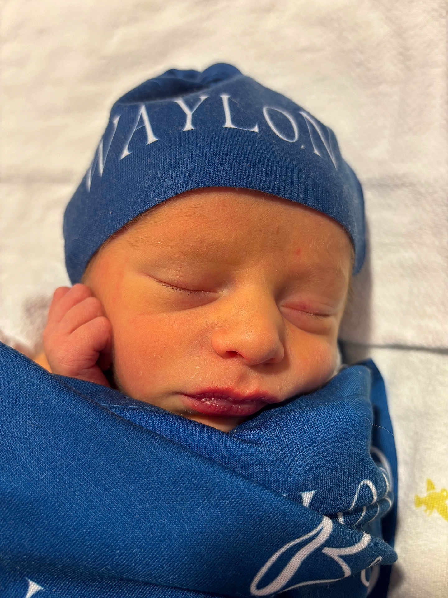 Waylon joined the competition — help win amazing prizes! newborn, baby, sleeping, blue_cloth, hat, wrapped, peaceful, face, headwear, infant, closeup, soft_light, blanket, portrait, cute, skin, resting, indoors, tiny, cozy