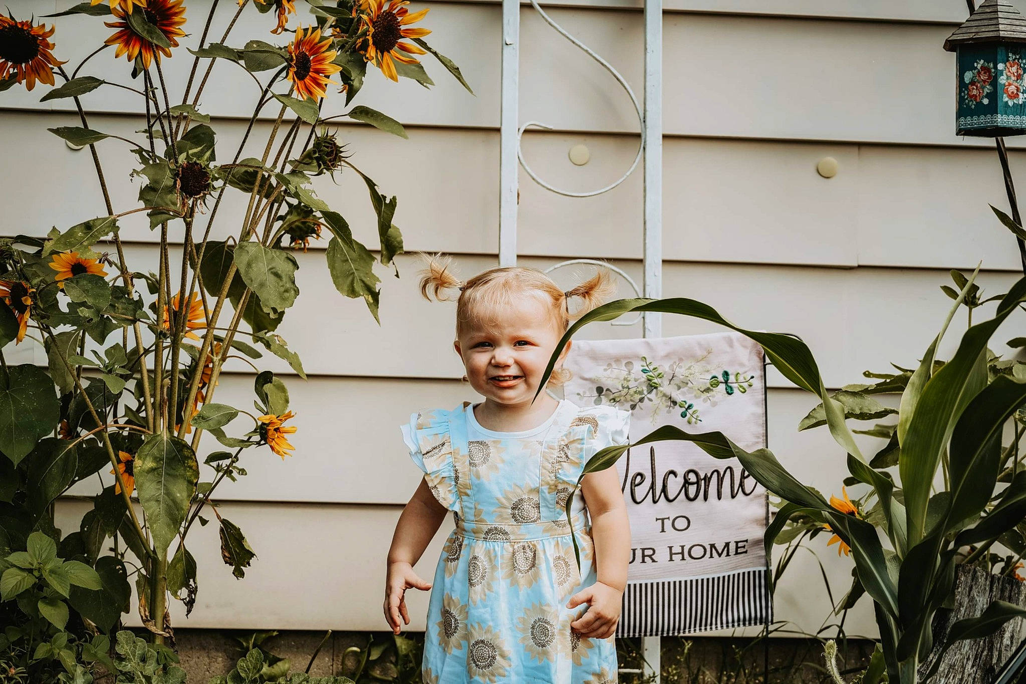 Evelyn joined the competition — help win amazing prizes! building, child, flash_photography, floral_design, flower, flower_arranging, flowering_plant, garden, grass, happy, house, joy, leaf, person, plant, smile, spring, standing, t_shirt, toddler