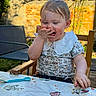 brick_wall, butterfly, child, cute, eating, face, food, garden, hand, happy, high_chair, messy, outdoor, playful, summer, sunlight, table, tablecloth, toddler, wooden_chair