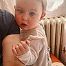 Leyah participe au concours pour gagner de l'argent avec cette photo : arm, baby, blue_eyes, child, closeup, clothing, curtain, cushion, expression, face, hand, holding, indoor, long_sleeve, natural_light, person, portrait, radiator, skin, tattoo
