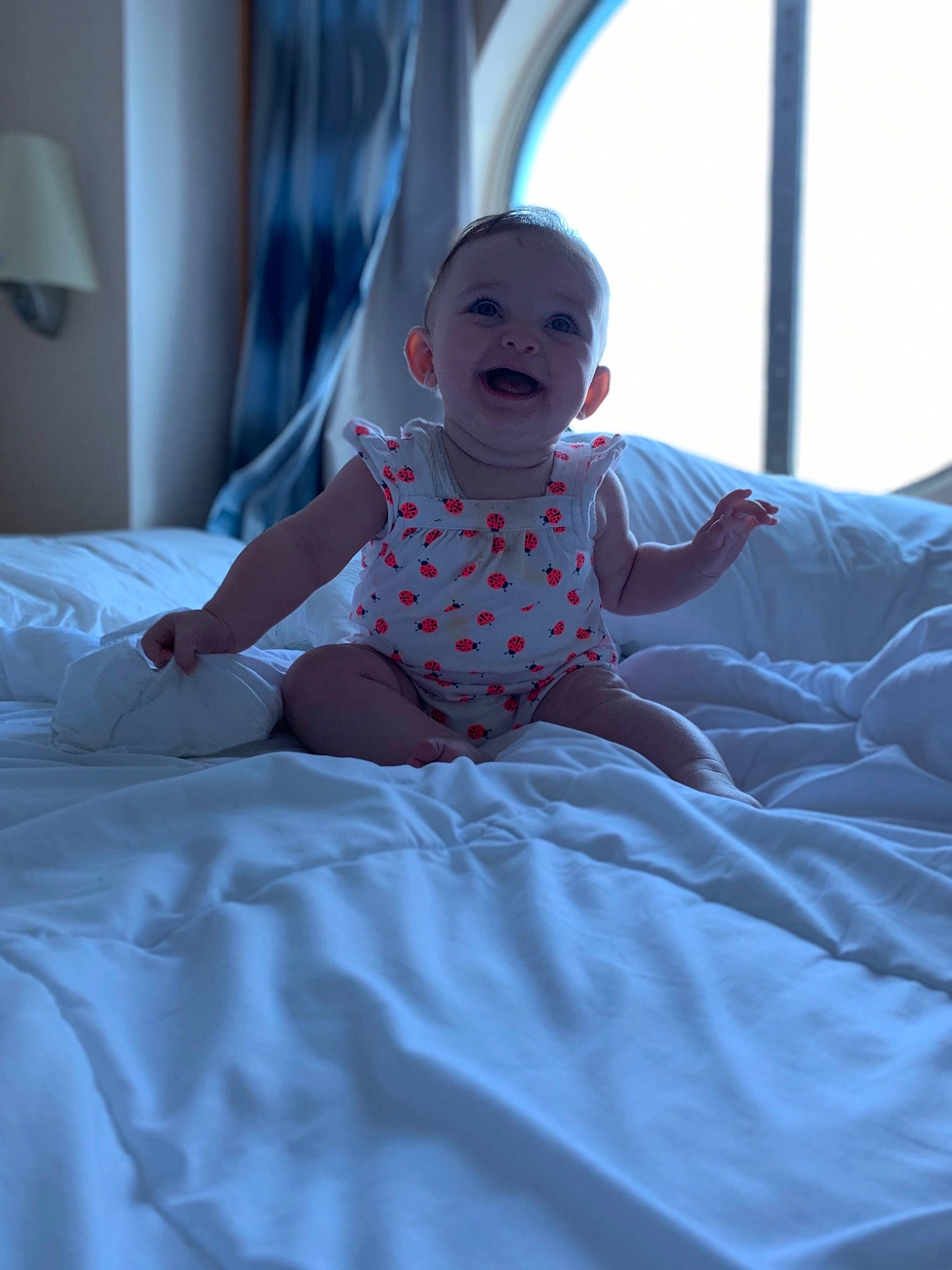 Isabella Rose is registered to the contest to win money with this photo: baby, bed, bed_sheet, bedding, birth, blue, child, comfort, furniture, linens, person, room, skin, smile, textile, toddler, vacation