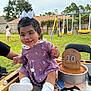 baby, child, outdoor, grass, swing, playground, cake, birthday, purple_dress, white_bow, smiling, happy, person, sock, table, chair, celebration, toy, fence, daylight