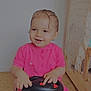 bed, blanket, carpet, child, cute, floor, furniture, happy, indoors, person, pink_dress, playtime, room, sitting, smiling, steering_wheel, toddler, toy_car, wet_hair, young_child