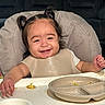 toddler, child, smiling, high_chair, pigtails, messy, food, meal, plate, bib, happy, indoor, person, cute, baby, face, table, eating, fun, expression