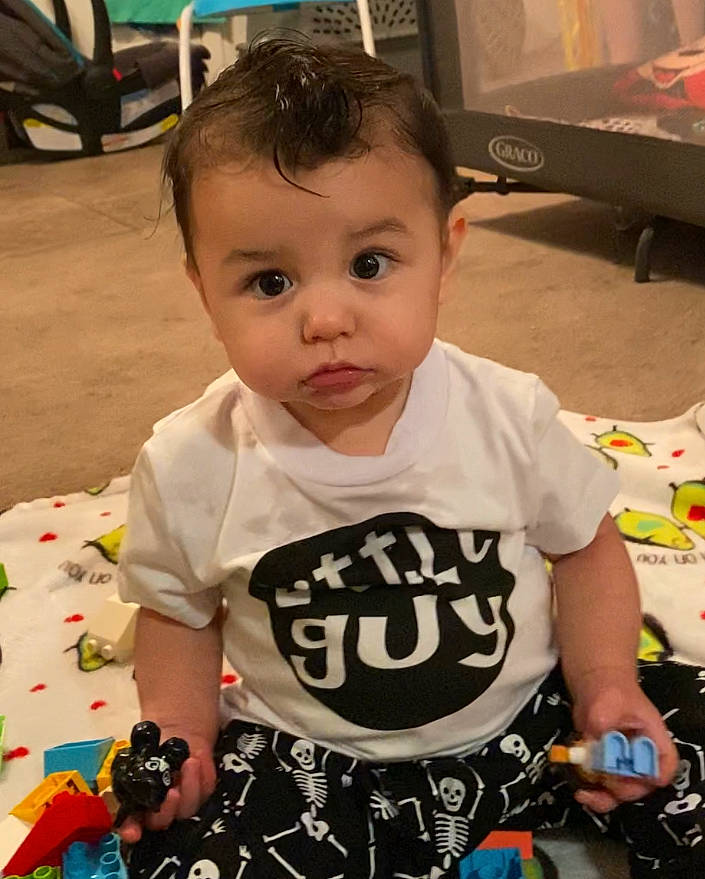 Jakob is registered to the contest to win money with this photo: baby, baby_toddler_clothing, cheek, child, cool, flooring, fun, happy, pattern, person, play, product, sitting, skin, sleeve, t_shirt, television, television_set, toddler, top