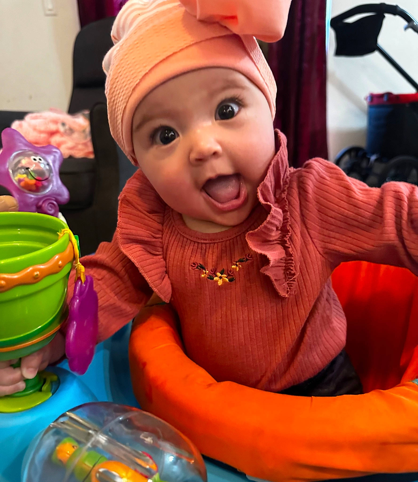 Marabella joined the competition — help win amazing prizes! baby, baby_toddler_clothing, beanie, cap, cheek, child, event, fun, happy, headwear, microphone, party, party_supply, person, plastic, play, purple, sitting, surprise, sweetness