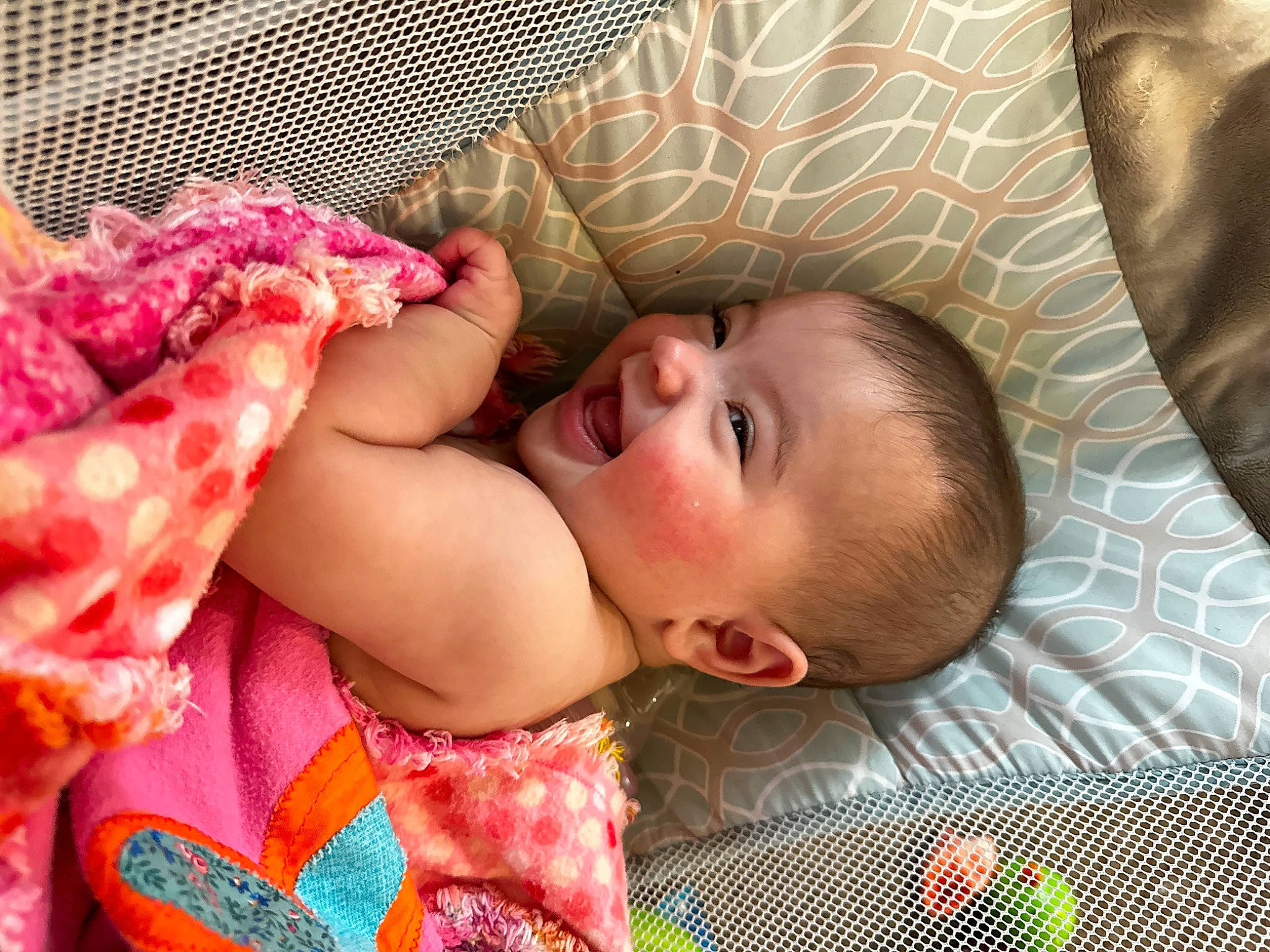 Marabella is registered to the contest to win money with this photo: baby, baby_toddler_clothing, cheek, child, comfort, dress, eye, face, finger, hand, happy, head, human_body, iris, linens, lip, mouth, nose, person, skin