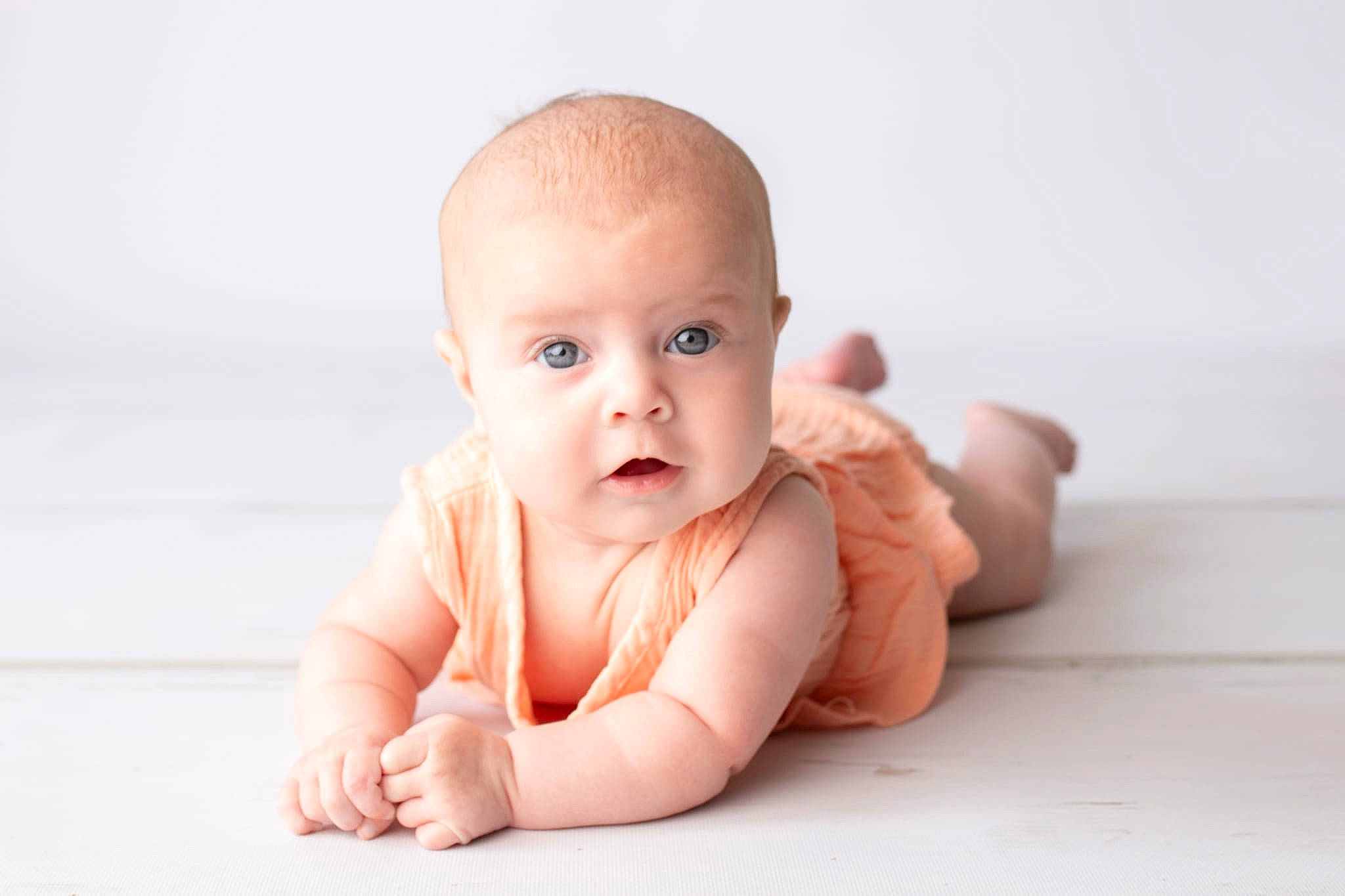 Mallory is registered to the contest to win money with this photo: baby, baby_toddler_clothing, cheek, eye, face, finger, flash_photography, flooring, gesture, hand, happy, human_body, iris, lip, nail, nose, person, stomach, thumb, toddler