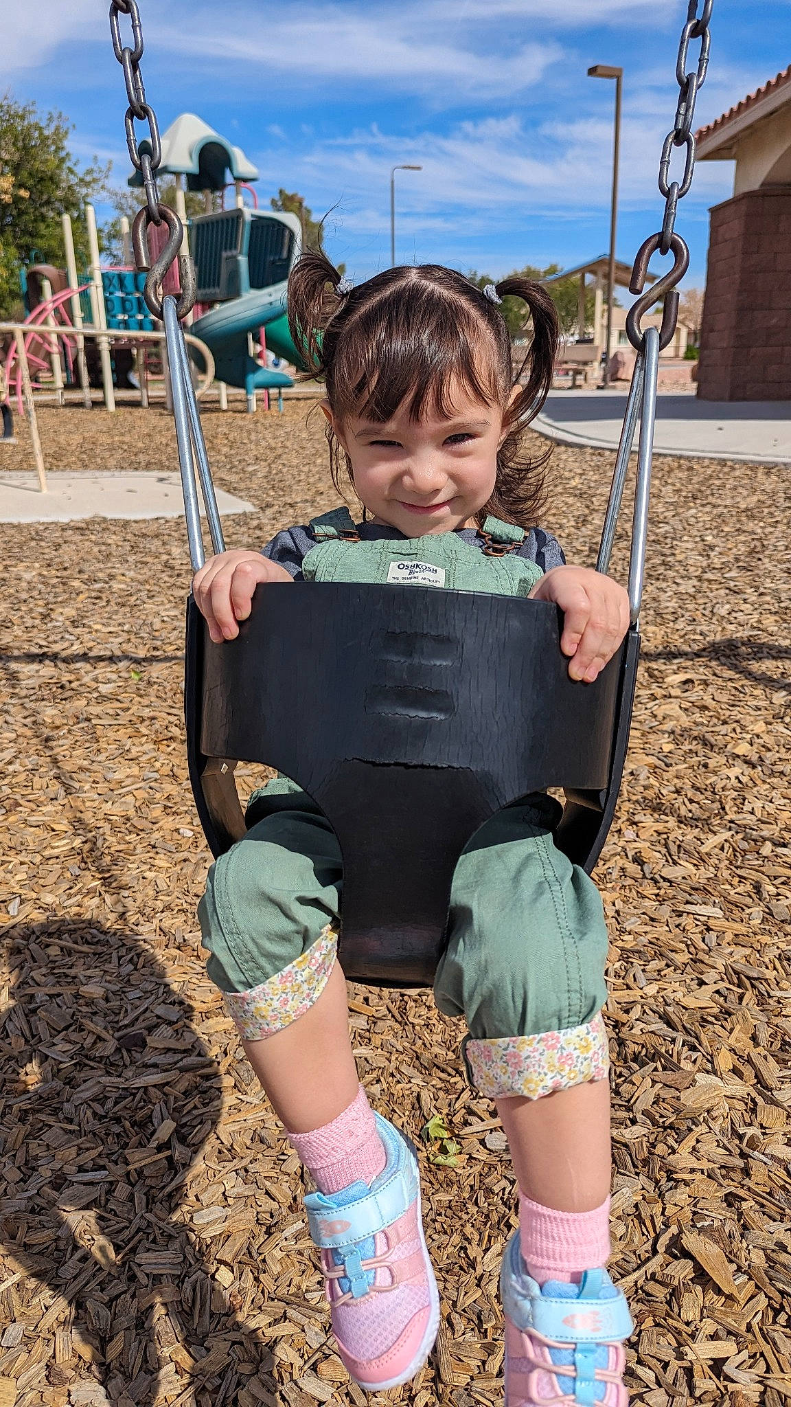 Abigail is registered to the contest to win money with this photo: blue, child, city, cloud, fun, grass, happy, joy, leisure, person, playground, recreation, sky, sleeve, smile, sock, soil, swing, t_shirt, thigh
