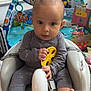 Alexander joined the competition — help win amazing prizes! baby, infant, baby_seat, toy, yellow_toy, play_gym, manta_ray_toy, colorful, curious, indoor, carpet, child, cute, clothing, foot, hand, face, expression, room, window