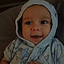 Alexander is registered to the contest to win money with this photo: baby, infant, hoodie, clothing, smile, face, hand, cute, child, portrait, eyes, apparel, babywear, lying_down, soft_surface, indoors, happy, expression, headwear, casual