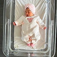 Violette participe au concours pour gagner de l'argent avec cette photo : baby, newborn, sleeping, hospital, bassinet, pink, white, turban, pacifier, clothing, infant, cute, cozy, socks, bed, resting, peaceful, person, child, indoor