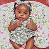 baby, infant, child, girl, floral_dress, headband, cushion, pattern, indoor, cute, smiling, portrait, skin, sitting, young_child, person, happy, colorful, flower_pattern, comfortable