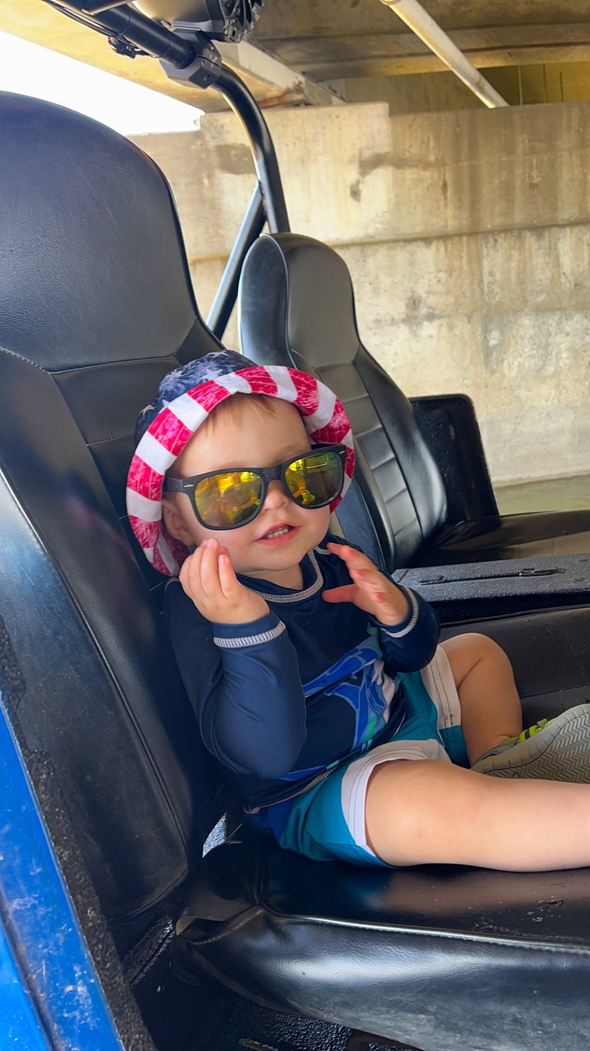 Paxton is registered to the contest to win money with this photo: auto_part, automotive_design, car, car_seat, car_seat_cover, comfort, eyewear, fun, goggles, head_restraint, human_leg, leg, motor_vehicle, person, personal_protective_equipment, steering_part, steering_wheel, sunglasses, thigh, vehicle_door