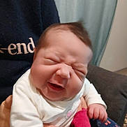 Kayline participe au concours pour gagner de l'argent avec cette photo : baby, infant, person, face, expression, smile, hand, clothing, sweater, sock, indoor, furniture, curtain, holding, cute, newborn, portrait, child, happy, scrunched_face