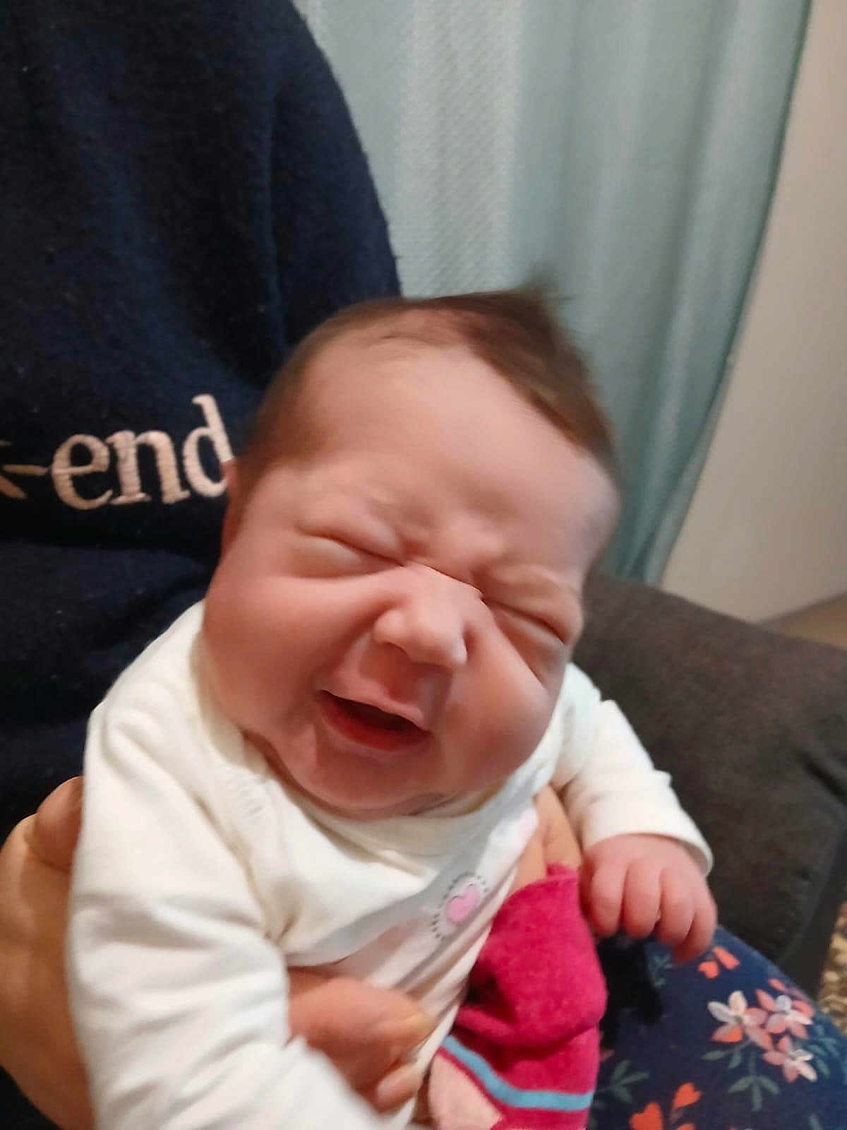 Kayline participe au concours pour gagner de l'argent avec cette photo : baby, infant, person, face, expression, smile, hand, clothing, sweater, sock, indoor, furniture, curtain, holding, cute, newborn, portrait, child, happy, scrunched_face